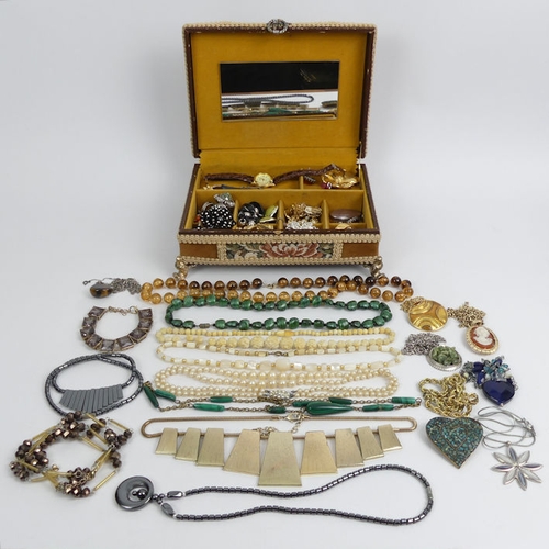 95 - A box of mixed costume jewellery, including silver pendants.