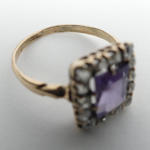 105 - 14/15ct gold (tested) purple sapphire and diamond ring, 2.6 grams.