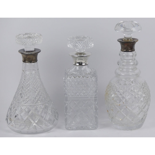 167 - Three silver topped glass decanters and a silver rimmed fruit bowl, London 1958, 22cm x 10cm.