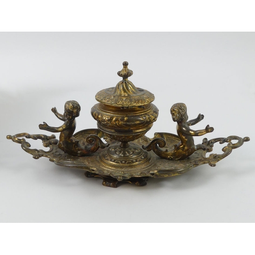 240 - A 19th century brass figural inkstand, 25cm x 12cm.