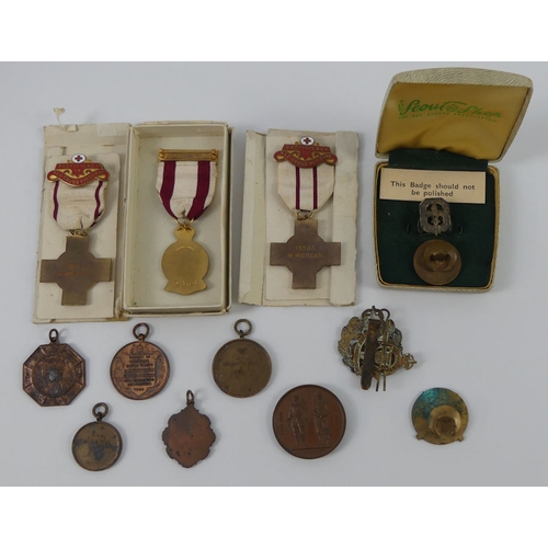 251 - Various medals and badges, including three WWII Red Cross medals, ATS cap badge, five shooting medal... 