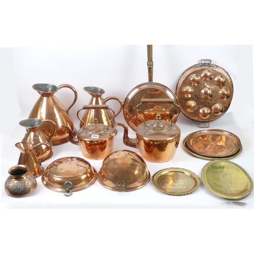 253 - A set of four graduated copper ale jugs together with two large copper kettles, a copper mould, siev... 