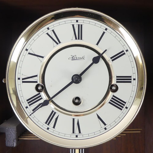 297A - Hermle chiming wall clock, with key and pendulum. 68 x 29cm.