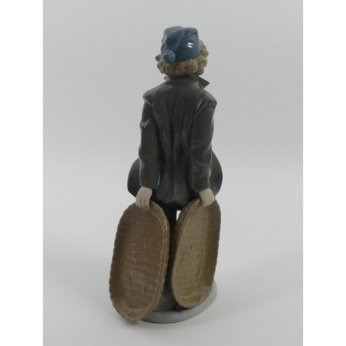 301 - Boxed Lladro figure 'Boy with Fish Baskets', 26cm.