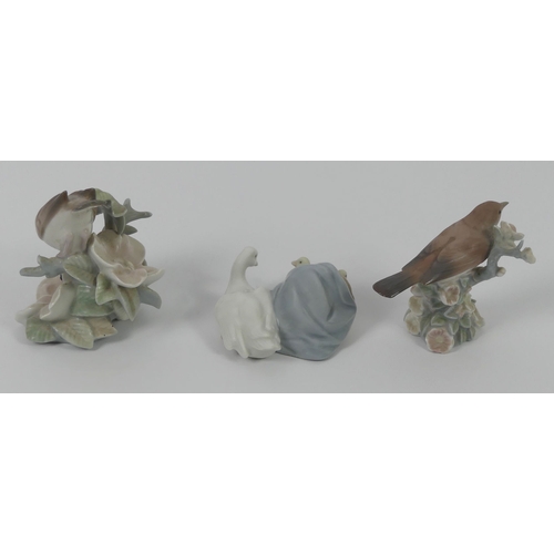 326 - Two Lladro porcelain bird figurines and a duck and ducklings group, 12cm.