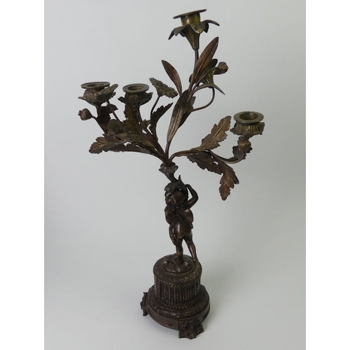 260 - 19th century bronze figural candelabrum with an inset porcelain panel. 46cm high.