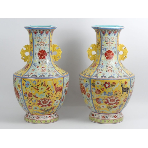 352 - A large pair of Chinese yellow and turquoise ground vases decorated with Flora and Fauna, 50cm.  Col... 