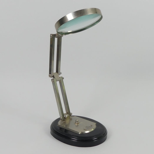 303 - An opticians magnifying glass on stand, 42cm.