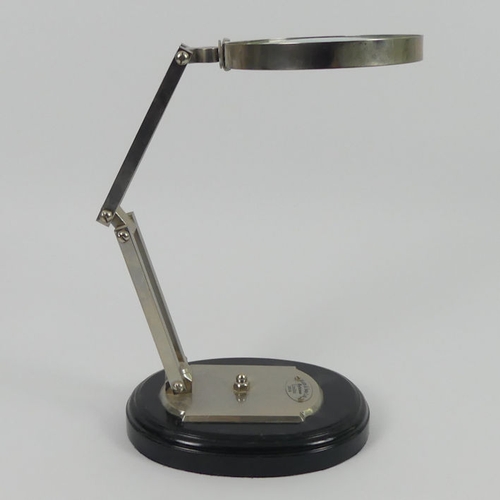 303 - An opticians magnifying glass on stand, 42cm.