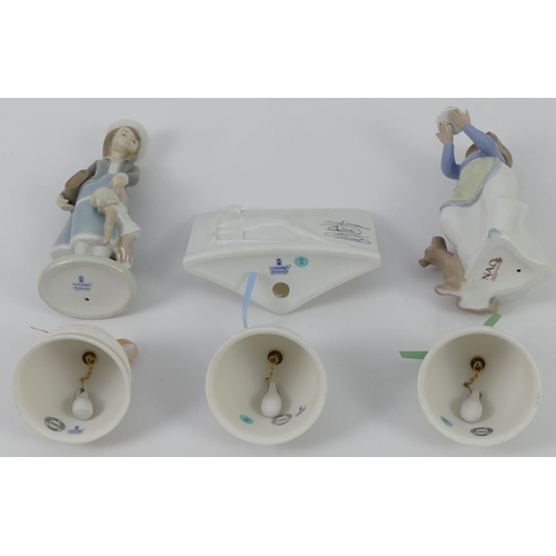 370 - A Lladro figure 5218 'Autumn' a Nao figure 1045 'Puppies Birthday', three Lladro bells and a Lladro ... 