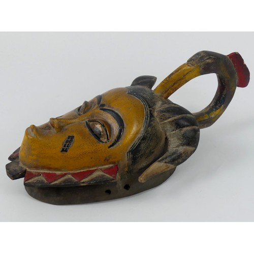 441 - A carved African tribal Gura mask, 43cm x 19cm.