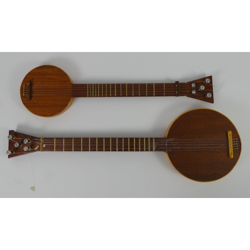 309 - Two mahogany five string banjos in fitted wooden cases, 65cm and 77 cm.