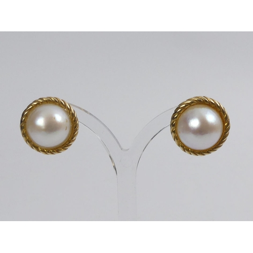 11 - A pair of 9ct gold Mabe pearl earrings, 8.7 grams, 18.3mm diameter.