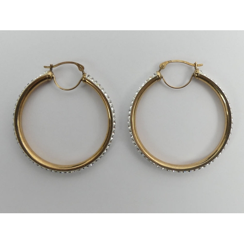 19 - A pair of 9ct gold crystal set hoop earrings, 2.3 grams, 32mm diameter.