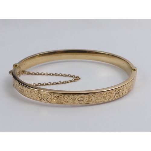 48 - 9ct gold scrolling foliate design hinged bangle, Birm. 1948, 8.8 grams, 6.3mm.