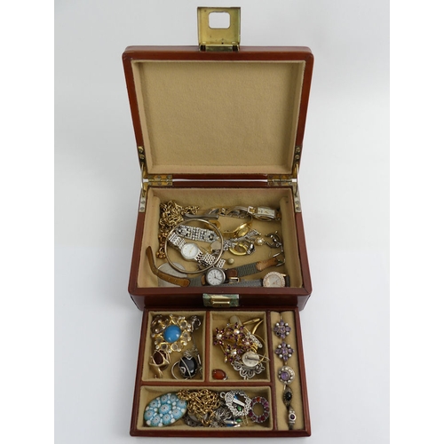 53 - A jewellery box and contents including silver rings and ladies watches.