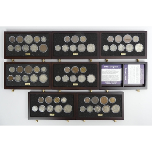 130 - A mahogany collectors cabinet, containing British coins of WWII, cabinet 18cm x 25cm x 14cm.
In good... 