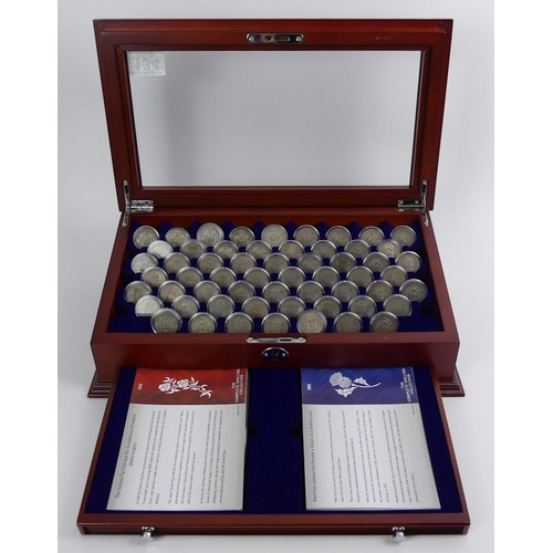 134 - A mahogany cabinet containing The Complete Shilling Coin collection.