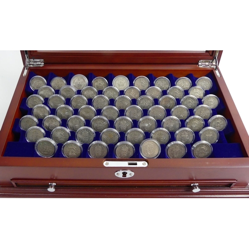 134 - A mahogany cabinet containing The Complete Shilling Coin collection.