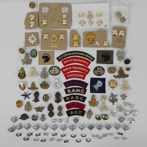 226 - A quantity of military cap badges, buttons and badges together with Police buttons and badges.