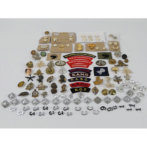 226 - A quantity of military cap badges, buttons and badges together with Police buttons and badges.