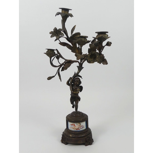 260 - 19th century bronze figural candelabrum with an inset porcelain panel. 46cm high.