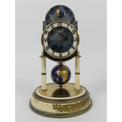 282 - A glass dome covered anniversary time clock with zodiac dial and world globe pendulum by Kaiser, 27c... 