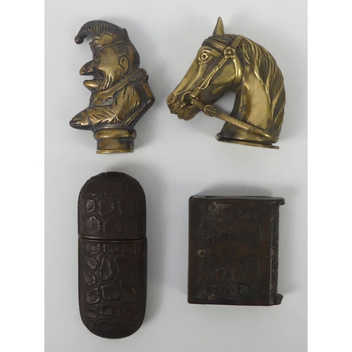 293 - Four novelty vesta cases including a brass Mr Punch and a horses head. Largest 7 cm.