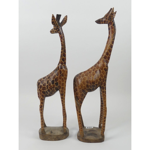 304 - A large pair of carved wooden giraffes. H60cm x W16cm.