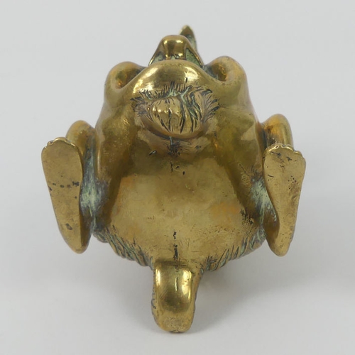 307 - A Victorian grotesque brass inkwell and penholder. 8 cm high.