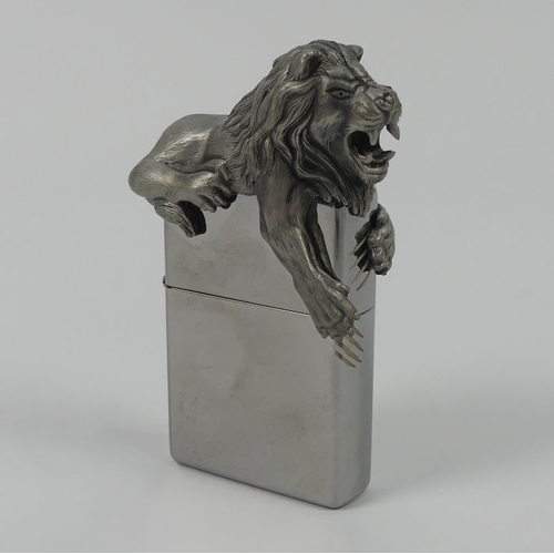 312 - A limited edition Zippo lighter No 338/2500 with figure of a lion to the flip top, boxed with instru... 