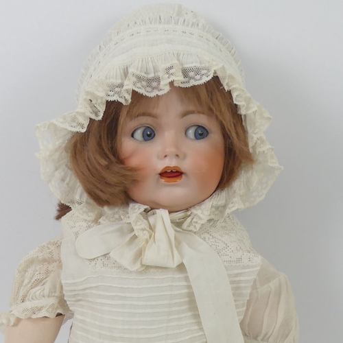 324 - J.D. Kestner bisque headed doll 257 with composition body and impressed marks to head, 70cm.