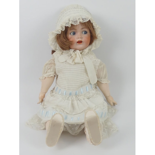 324 - J.D. Kestner bisque headed doll 257 with composition body and impressed marks to head, 70cm.