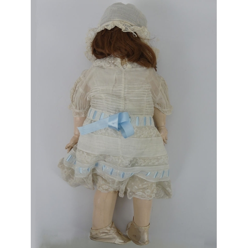 324 - J.D. Kestner bisque headed doll 257 with composition body and impressed marks to head, 70cm.