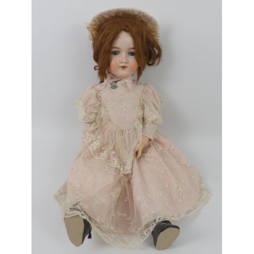 325 - Armand Marseille bisque headed doll 390 with impressed marks to head, 68cm.