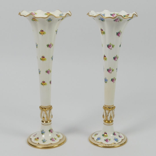 354 - A pair of Minton vases of trumpet form, decorated with hand painted roses and pansies with gilt bord... 