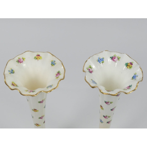 354 - A pair of Minton vases of trumpet form, decorated with hand painted roses and pansies with gilt bord... 