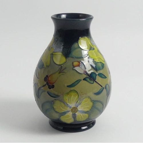 369 - Moorcroft Hypericum vase designed by Racel Bishop. 20 cm.