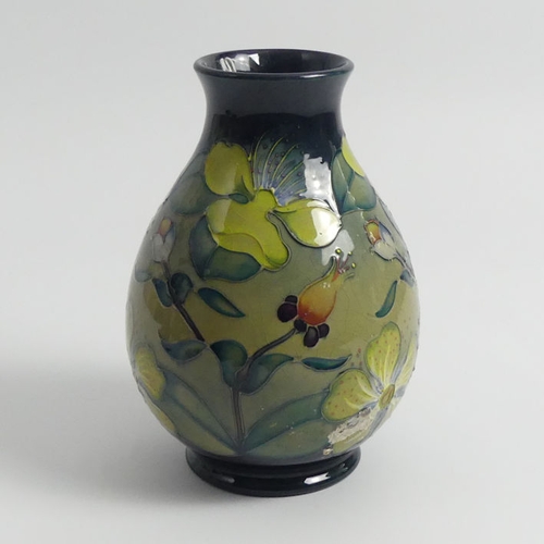 369 - Moorcroft Hypericum vase designed by Racel Bishop. 20 cm.