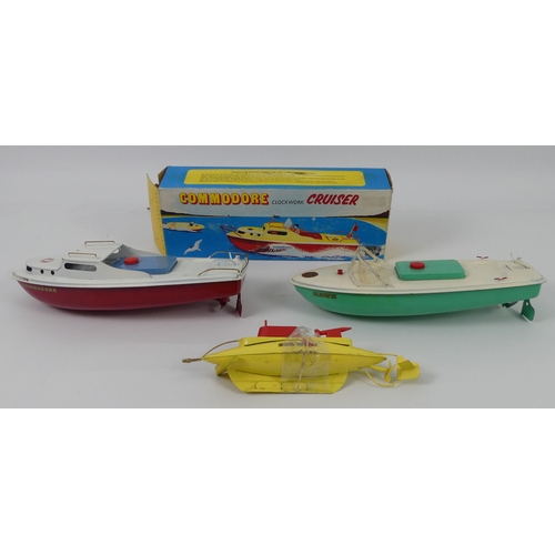 396 - A boxed tinplate Sutcliffe Commando Cruiser together with two unboxed Sutcliffe clockwork boats.