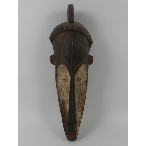 442 - A Gabon African carved tribal Fang mask. 53 x 16 cm.