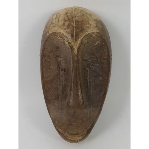 444 - A carved African Nail tribal mask from Gabon. 28 x 17 cm.