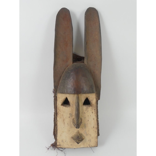 446 - A carved West African Mali Dogon mask. 50 x 15 cm.