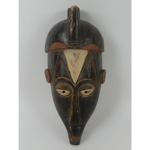 447 - A carved East African Nigerian Igbo mask. 37 x 16 cm.