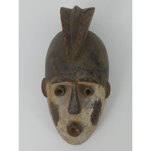 448 - A Burkino Faso carved Golunski tribal mask. 38 x 16 cm.