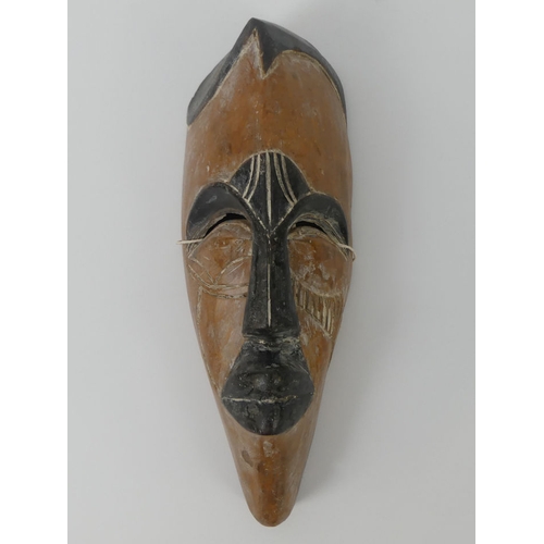 451 - A carved Africa Cameroon Tika tribal mask. 34 x 13 cm.