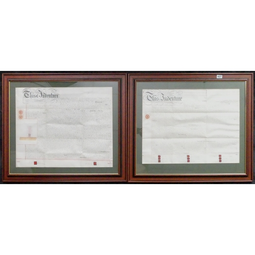 487 - Two framed and glazed 19th century indentures, together with an oil on canvas of a train signed John... 