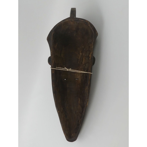 442 - A Gabon African carved tribal Fang mask. 53 x 16 cm.