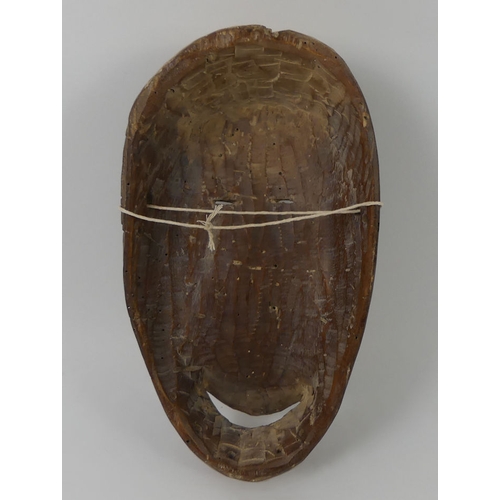 444 - A carved African Nail tribal mask from Gabon. 28 x 17 cm.