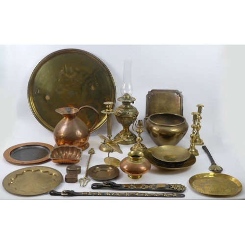 314 - A collection of copper and brassware including a copper ale jug, brass oil lamp, candlesticks, plate... 